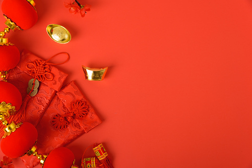 Chinese new year festival concept, flat lay top view, Happy Chinese new year with Red envelope and gold ingot on red background with copy space for your text