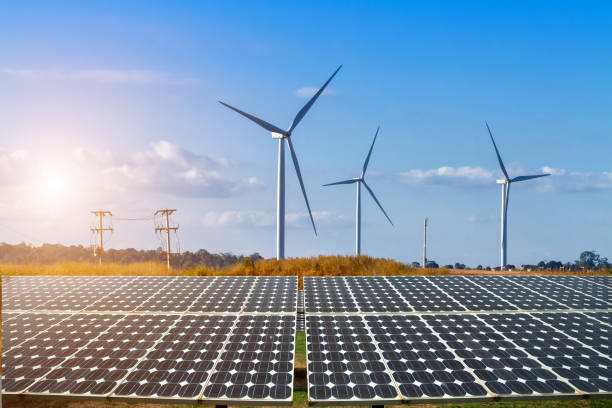 solar panels with wind turbines against mountanis landscape against blue sky with clouds,alternative energy concept,clean energy,green energy. - blue cloudscape contemporary electricity imagens e fotografias de stock