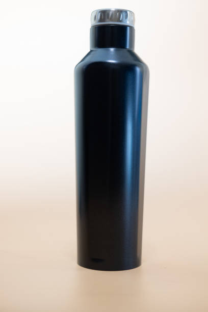 istock Stainless black thermos bottle for water on yellow background 1197417521