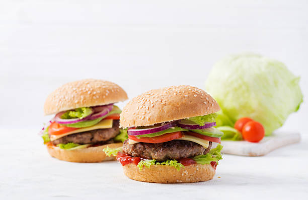 istock Big sandwich - hamburger burger with beef, avocado, tomato and red onions on light background. American cuisine. Fast Food 1197425467