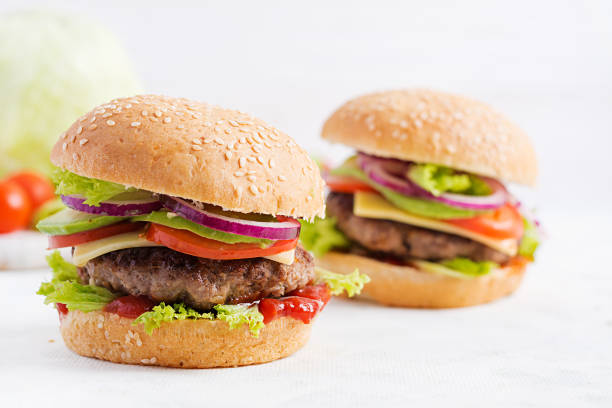 istock Big sandwich - hamburger burger with beef, avocado, tomato and red onions on light background. American cuisine. Fast Food 1197425474