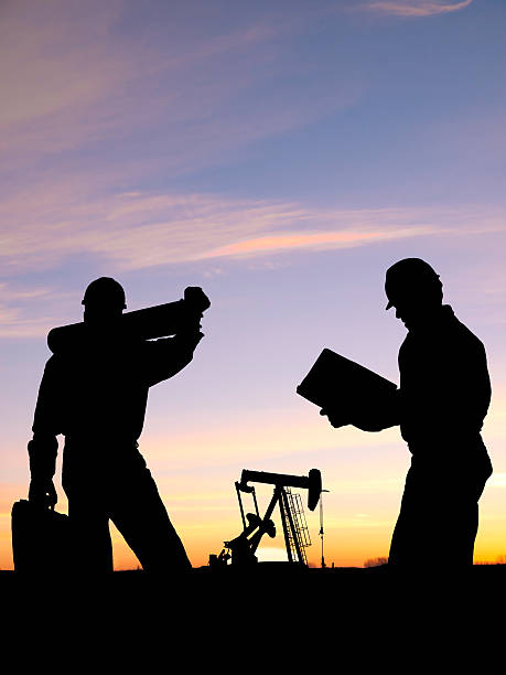 istock Oil Worker Engineers Confer at Pump 119742558