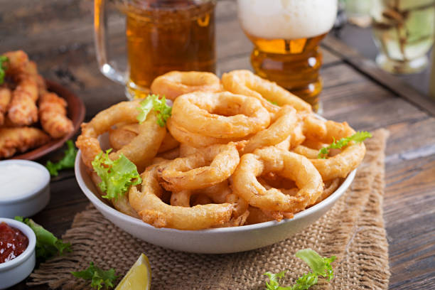 istock Onion rings in batter with sauce and cheese sticks. Beer snacks. Copy space 1197426953