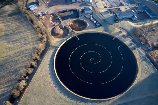 Sewage water works treatment plant aerial view from above showing waste quality round circular control tank uk
