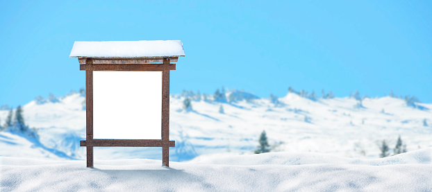 Wooden blank billboard on snowy mountain mock up. Empty space for text. Isolated white surface. Mockup for advertising banners