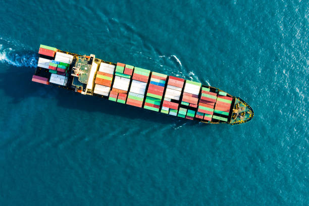 istock ontainer freight ship carrying container box for import and export business logistic and transportation by container ship in open sea, Aerial view 1197437040