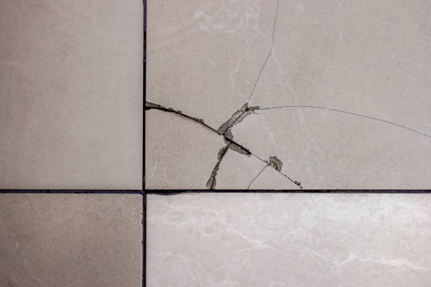 Cracked tile. Broken tile on the floor. stock photo