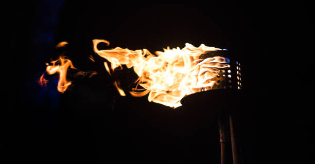 istock Burning Torch in the Night at black background 1197438881