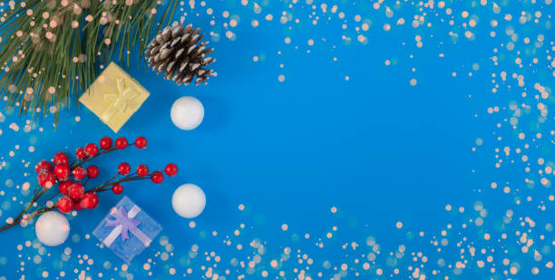 istock Christmas blue background. Gift or present box and holiday decoration top view. pine cone and decorative snowballs, Happy New Year greeting card 1197440006