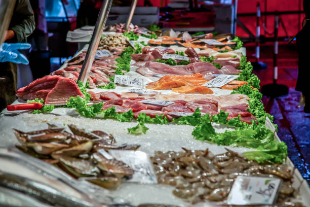 venetian fish market. the rialto fish market is located alongside the grand canal near the rialto bridge - venice, italy - market rialto bridge venice italy italy imagens e fotografias de stock