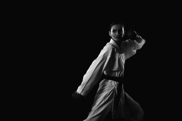 istock Young Woman Dressed In Traditional Kimono Black Background 1197444844