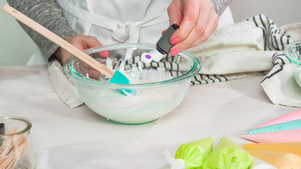 istock Mixing royal icing to decorate Easter sugar cookeis. 1197446097