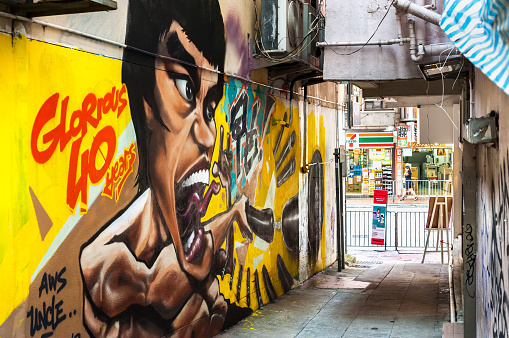 WANCHAI, HONG KONG - SEPT 9, 2013 - Graffitied mural of Hong Kong martial arts legend Bruce Lee in Wan Chai, Hong Kong