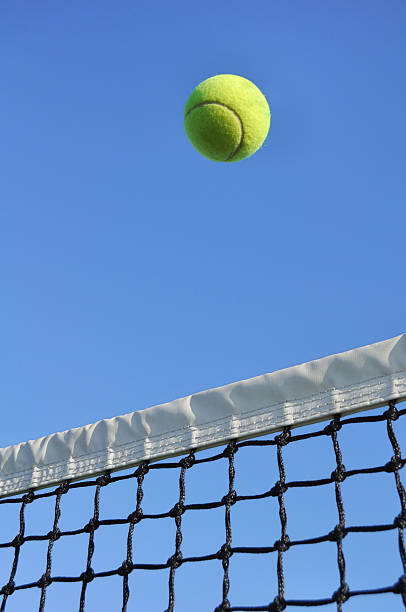 istock Tennis ball flying over the net 119744750