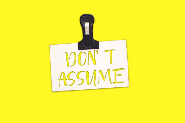 istock paperclip holding paper with don't assume 1197449055