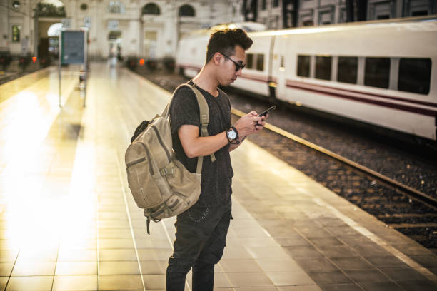 istock Young man on the railway station 1197453159