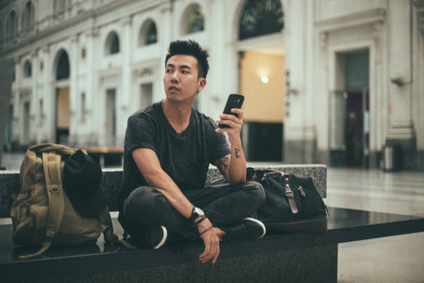 istock Hipster man on the railway station 1197453458