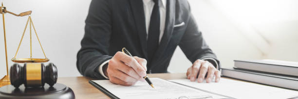 istock Close-Up Of Man Fountain Pen While Reading Document On Table 1197459812