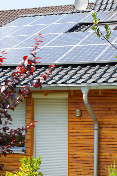 Solar energy panels on bungalow with wooden facade