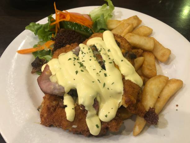 istock Chicken Parmigiana with bacon and chips 1197465596