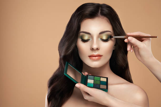istock Makeup artist applies eye shadow 1197466775