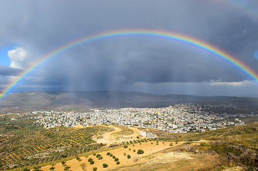 rainbow over the arab village Cana of Galilee ( Kafr Kanna ) in Israel , place where Christ showed first miracle