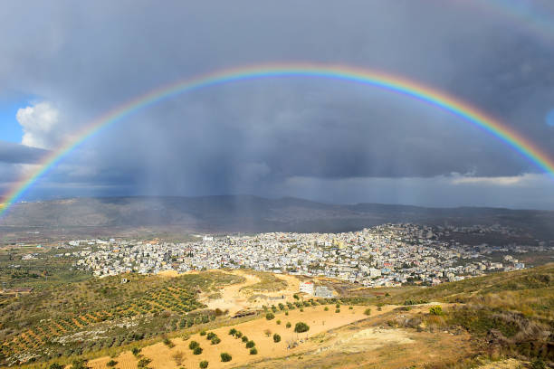 rainbow over Cana of Galilee after rain, Israel rainbow over the arab village Cana of Galilee ( Kafr Kanna ) in Israel , place where Christ showed first miracle galilee photos stock pictures, royalty-free photos & images