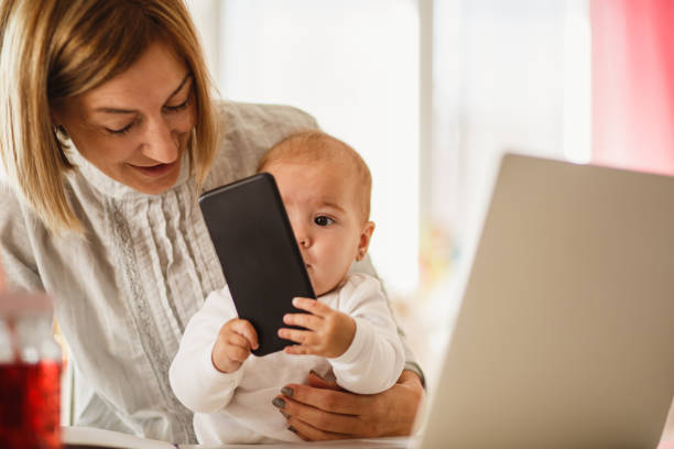 istock Baby holding and looking at the smartphone 1197470065