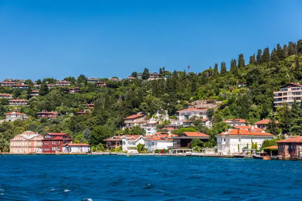 Beautiful builings and mansions at the costline and hillslope with green forest in summer, at Bosphorus Strait in Istanbul,Turkey. View from a Cruise Ship.