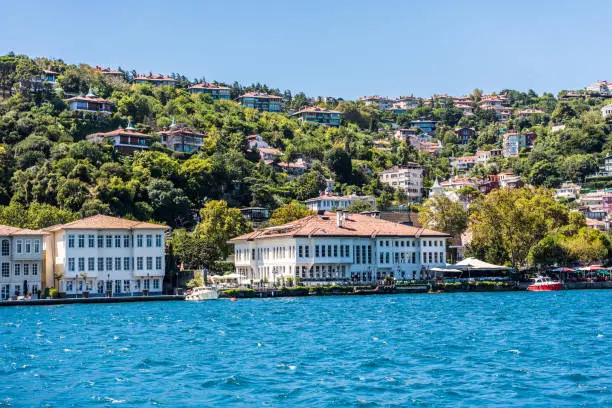 Beautiful builings and mansions at the costline and hillslope with green forest in summer, at Bosphorus Strait in Istanbul,Turkey. View from a Cruise Ship.