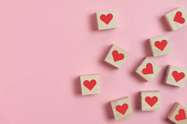 istock Heart in Wooden cubes on pink background. 1197473205