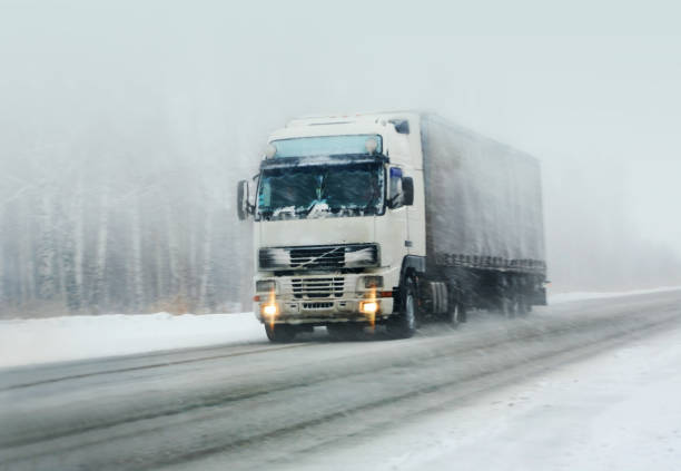 istock truck goes on winter road 1197473339