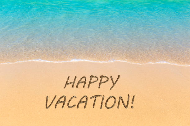 istock Happy Vacation written in a sandy tropical beach. 1197474324