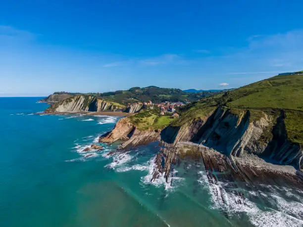 Photo of Aerial view of rock formations at Zumaia or Itzurun beach in Spain
