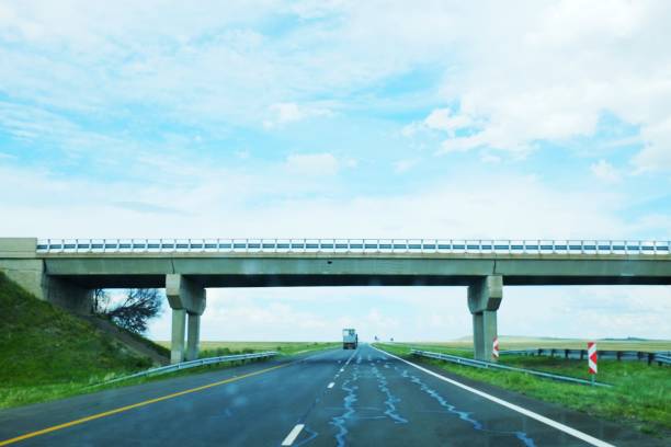 istock Remote highway, sky and cloud, with overpass and distant truck 1197475717
