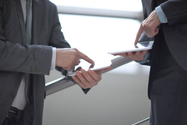 istock close up. two businessmen with tablet computers 1197476420