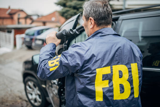 istock An FBI agent uses binoculars 1197476954