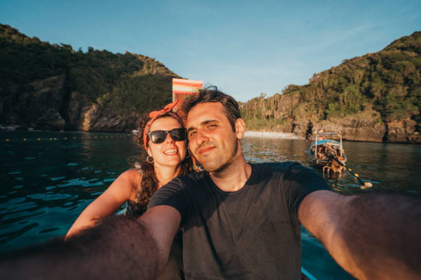 istock Young couple selfie on a longtail boat in Thailand, Phi Phi Island 1197476997