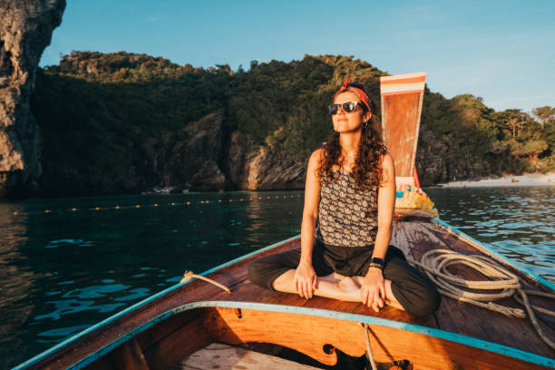 istock Young woman on a longtail boat in Thailand during sunset, Phi Phi Island 1197476998