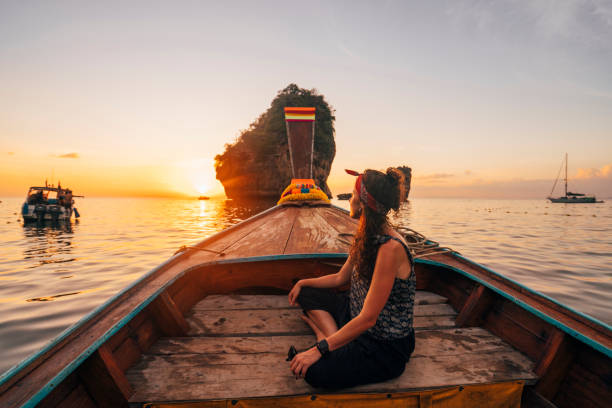 istock Young woman on a longtail boat in Thailand during sunset, Phi Phi Island 1197477005