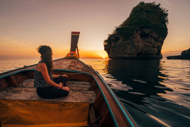 istock Young woman on a longtail boat in Thailand during sunset, Phi Phi Island 1197477006