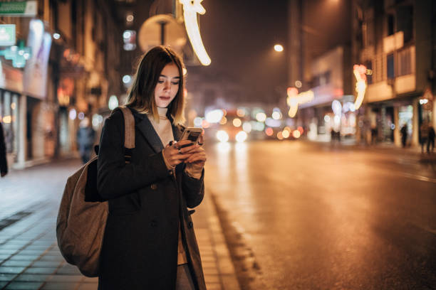 istock Young woman using mobile phone in the city 1197477609