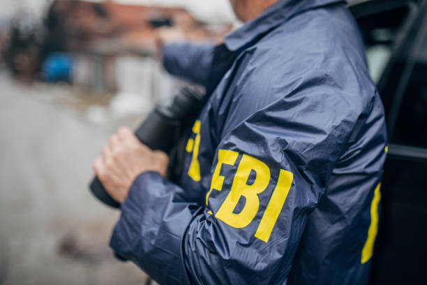 istock An FBI agent uses a gun and binoculars 1197477617