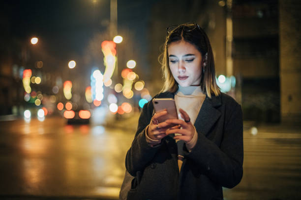 istock Young woman using mobile phone in the city 1197477633