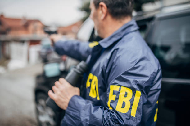 istock An FBI agent uses a gun and binoculars 1197477915