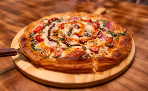 istock pizza with Pepperoni with vegetables and fresh ingredients on rustic wooden table 1197479070