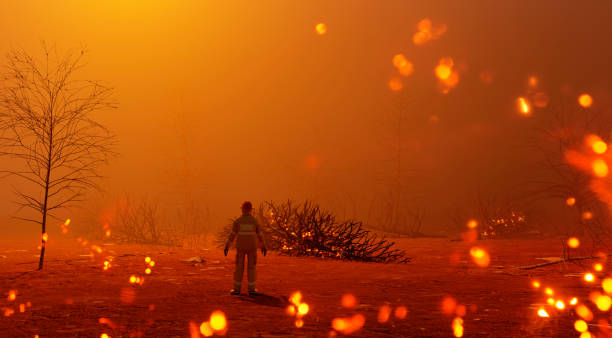 istock One fire fighter stands alone surrounded by flames from burning trees 1197479296