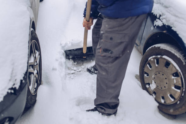 istock An older man is clearing snow next to his car 1197480137