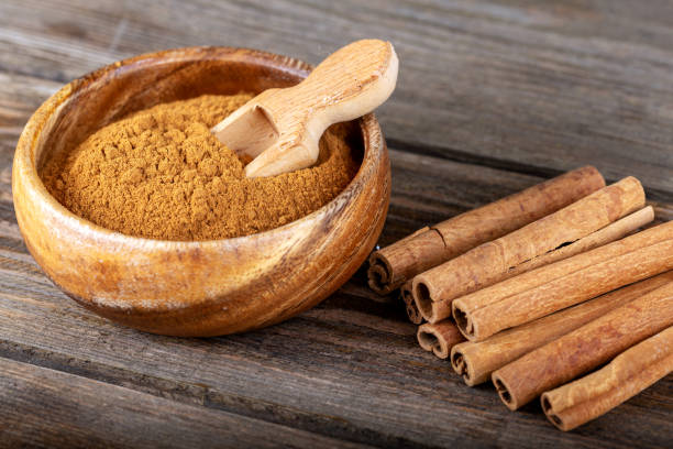 istock Cinnamon sticks and cinnamon powder on wood 1197480531