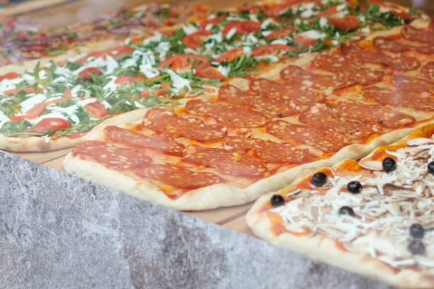 istock pizza for sale, slice of pizza behind display window  - 1197480653